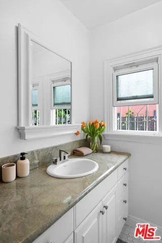 a bathroom with sink and mirror
