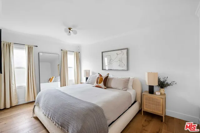 a bedroom with a bed and a night stand