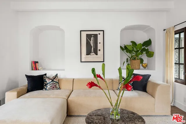a living room with furniture flowerpot and a window