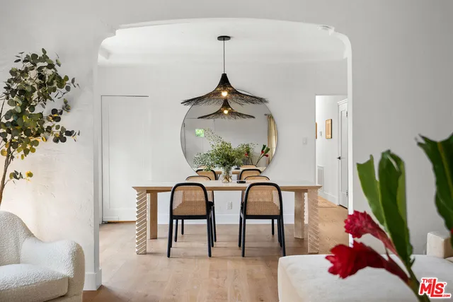 a dining room with furniture and wooden floor