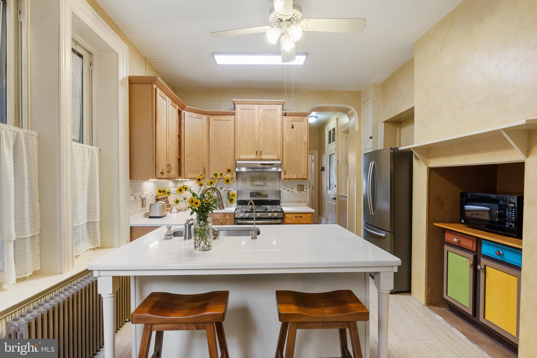 721 South George Street York, PA 17401 - Photo 20 of 78 a kitchen with a table chairs refrigerator and cabinets