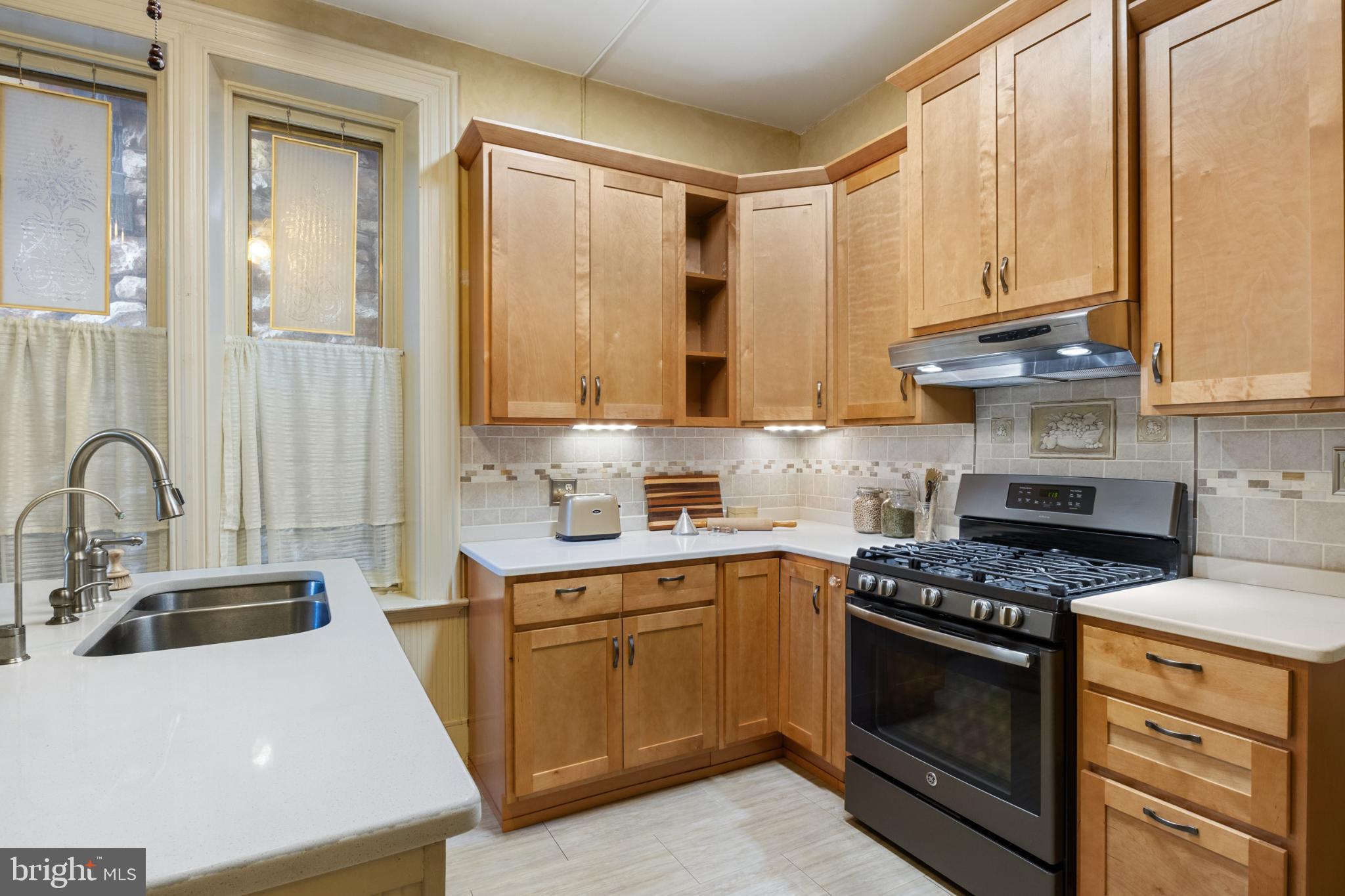721 South George Street York, PA 17401 - Photo 21 of 78 a kitchen with stainless steel appliances granite countertop a sink a stove and a refrigerator
