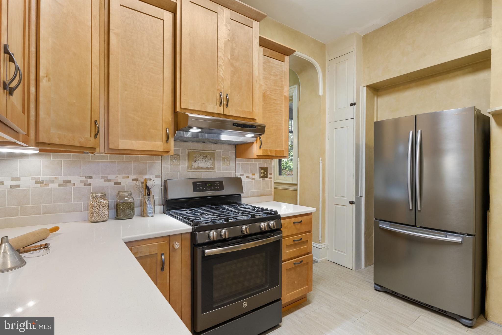721 South George Street York, PA 17401 - Photo 23 of 78 a kitchen with stainless steel appliances granite countertop a refrigerator stove and sink