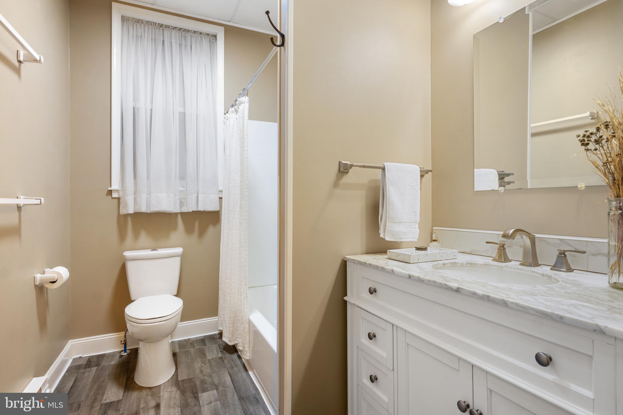 721 South George Street York, PA 17401 - Photo 27 of 78 a bathroom with a granite countertop sink toilet and shower