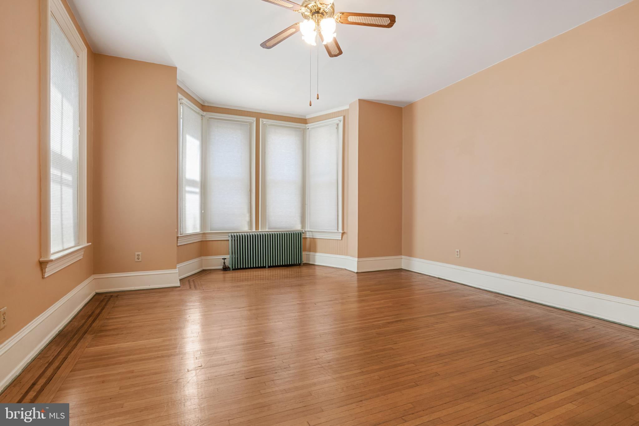 721 South George Street York, PA 17401 - Photo 32 of 78 a view of an empty room with a window and wooden floor