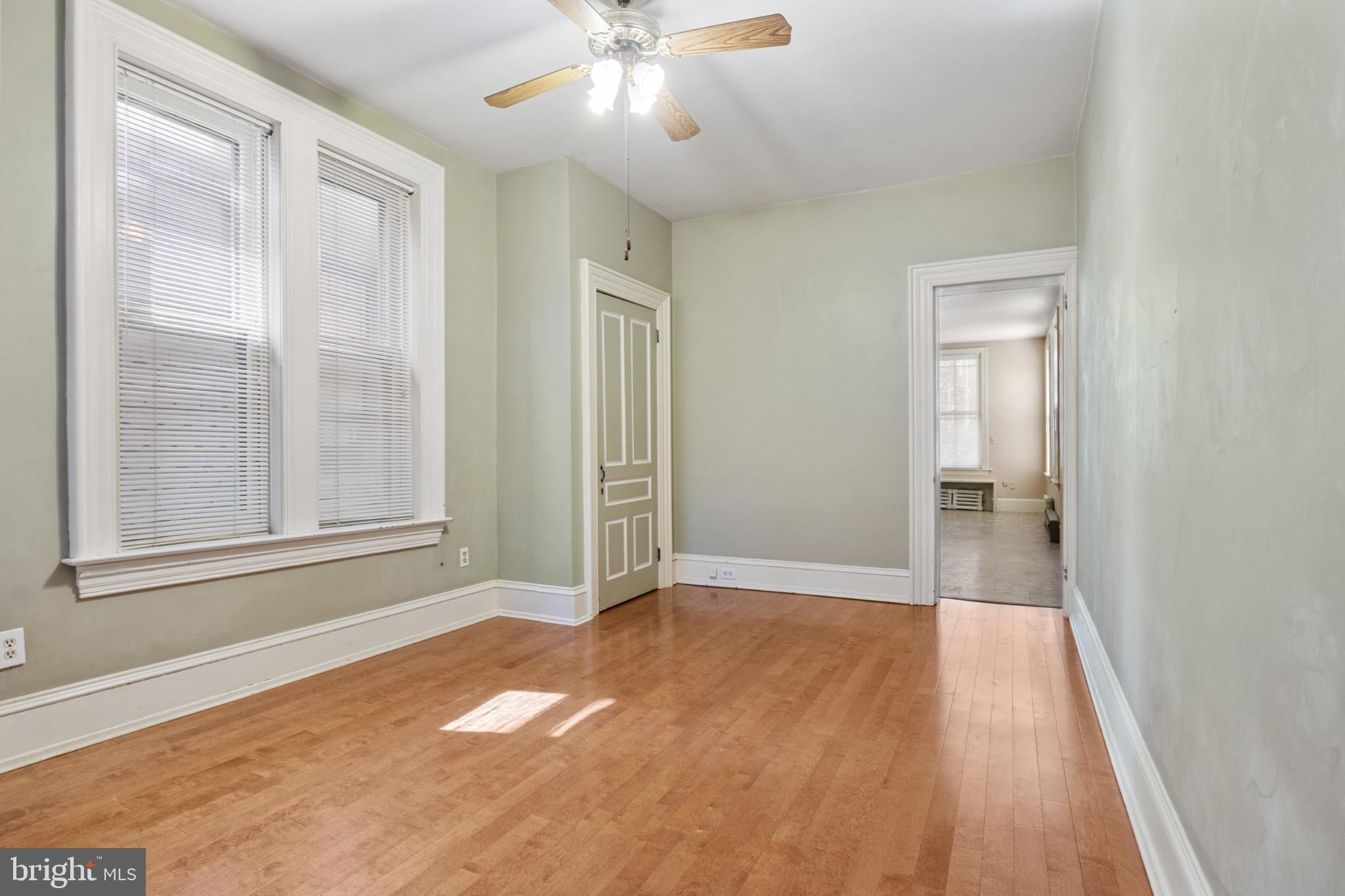 721 South George Street York, PA 17401 - Photo 39 of 78 a view of an empty room with wooden floor and a window