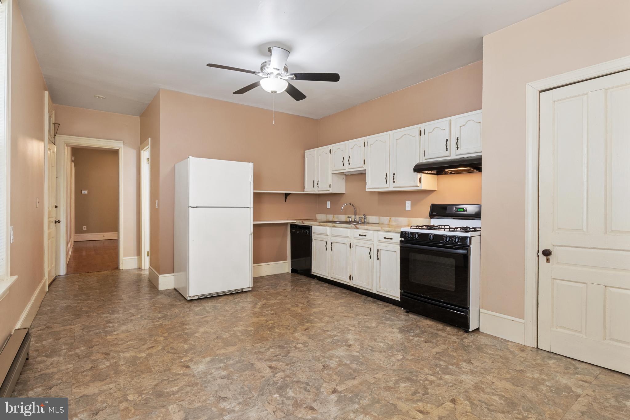 721 South George Street York, PA 17401 - Photo 41 of 78 a kitchen with stainless steel appliances a refrigerator sink and cabinets