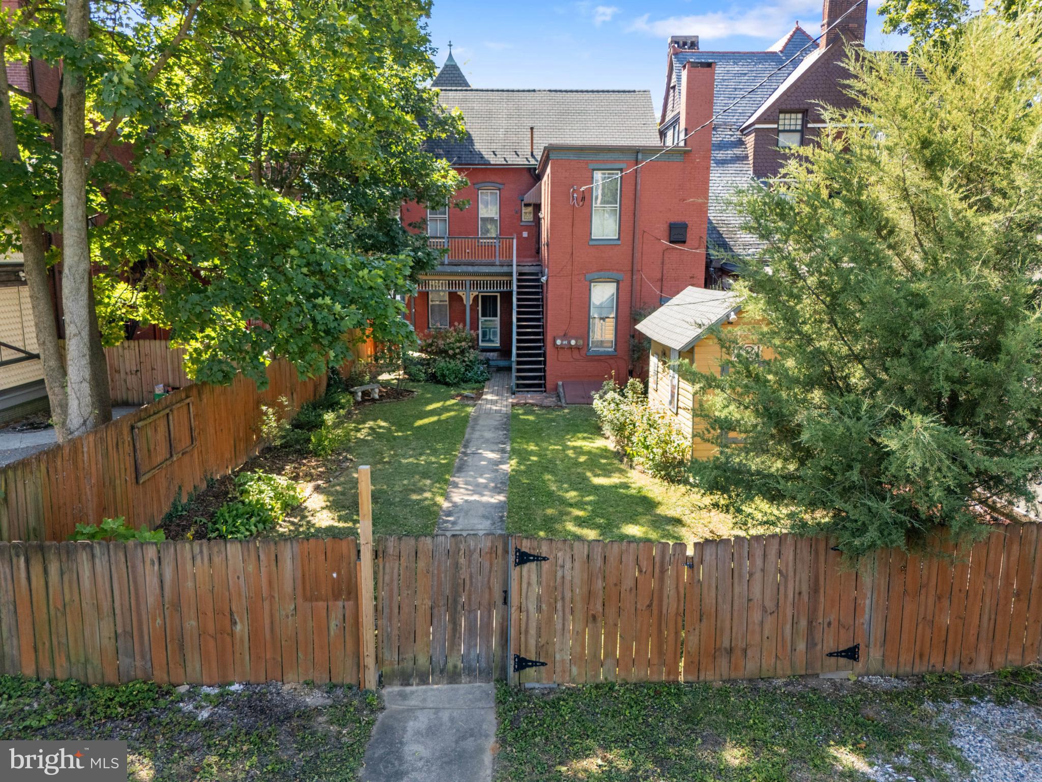 721 South George Street York, PA 17401 - Photo 65 of 78 a view of a house with a small yard and wooden fence