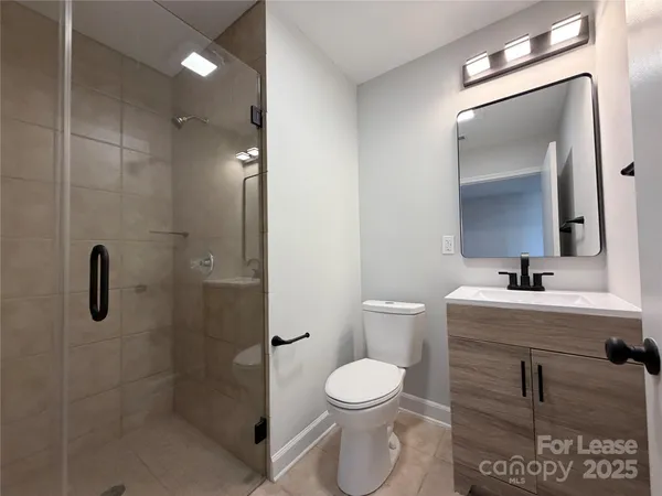 a bathroom with a toilet sink and shower