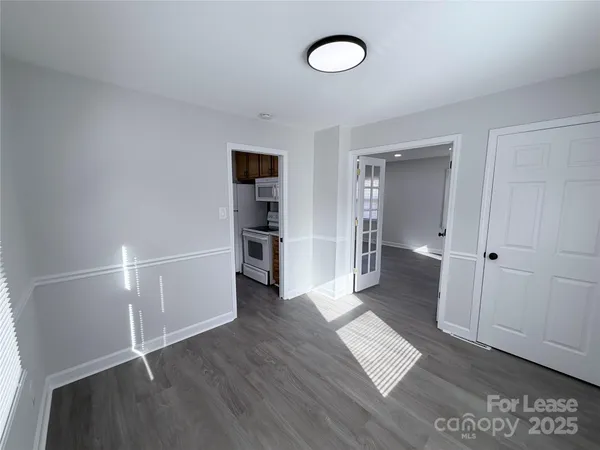an empty room with wooden floor and closet