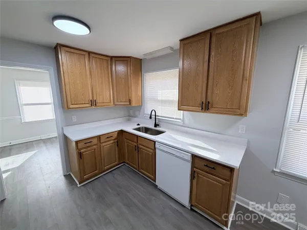 a kitchen with stainless steel appliances granite countertop wooden cabinets a sink and dishwasher