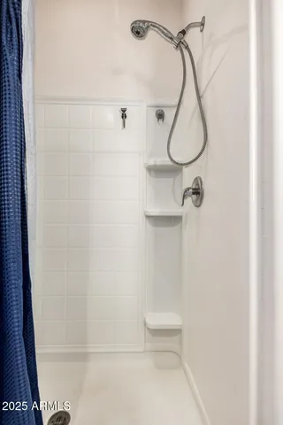 a bathroom with a shower and a shower