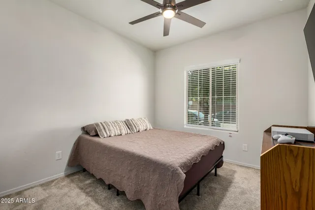 a bedroom with a bed and window
