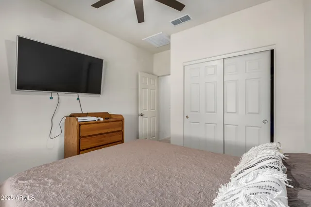 a bedroom with a bed and a flat screen tv