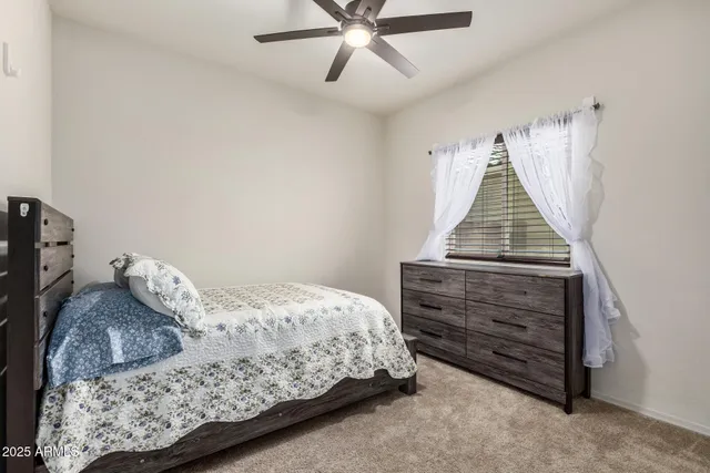 a bedroom with a bed and a dresser
