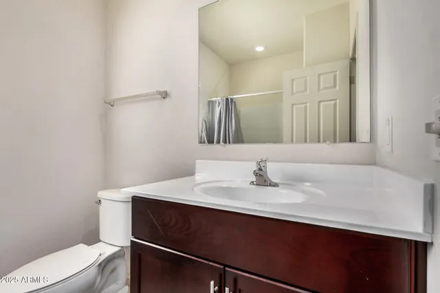 a bathroom with a sink vanity and a toilet