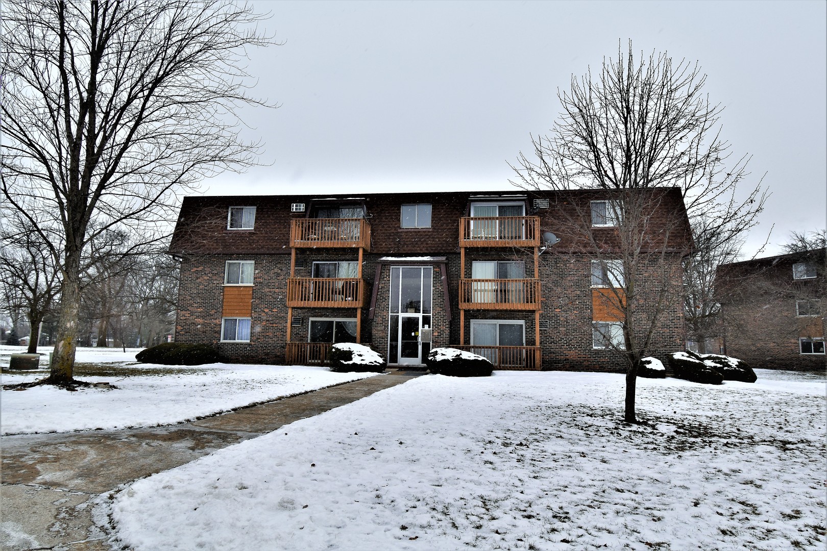 a view of a house with a snow in the yard