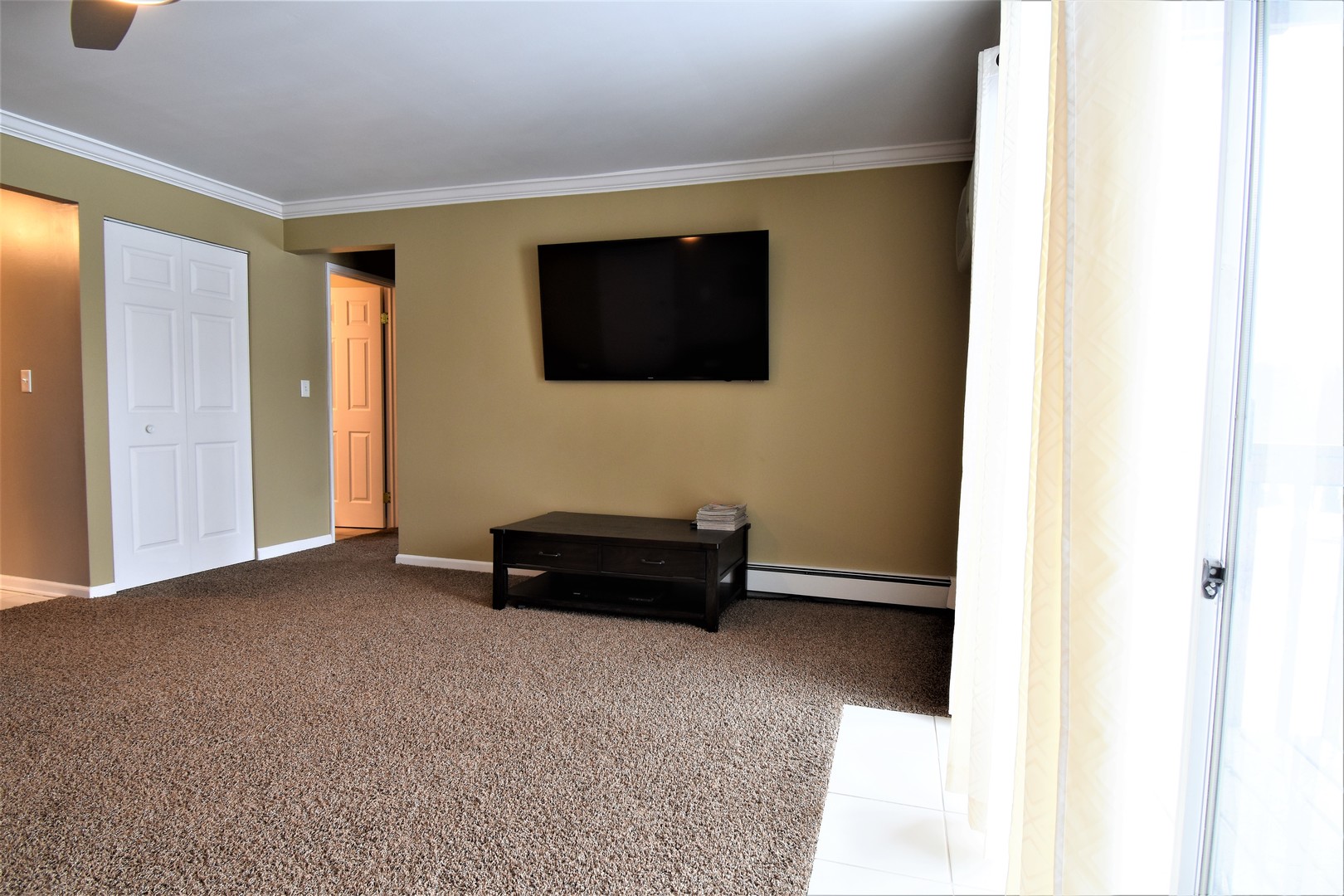 19330 Wolf Road, Unit 5 Mokena, IL 60448 - Photo 4 of 25 a living room with furniture and a flat screen tv