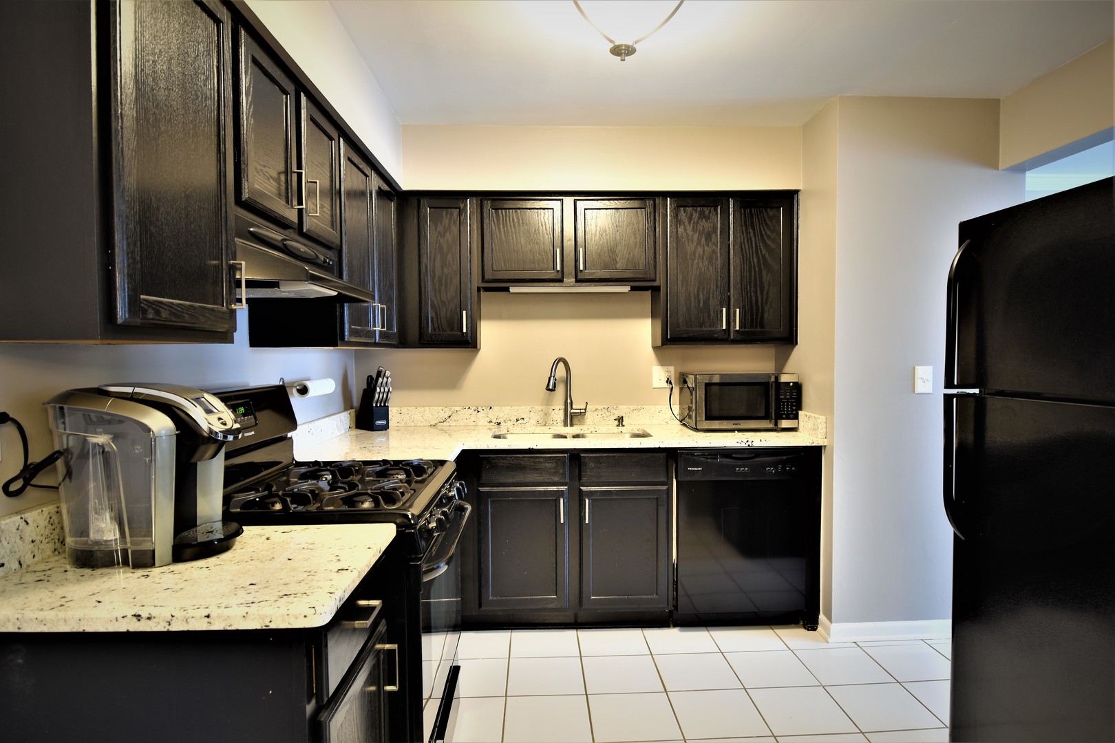 19330 Wolf Road, Unit 5 Mokena, IL 60448 - Photo 7 of 25 a kitchen with a sink refrigerator and cabinets