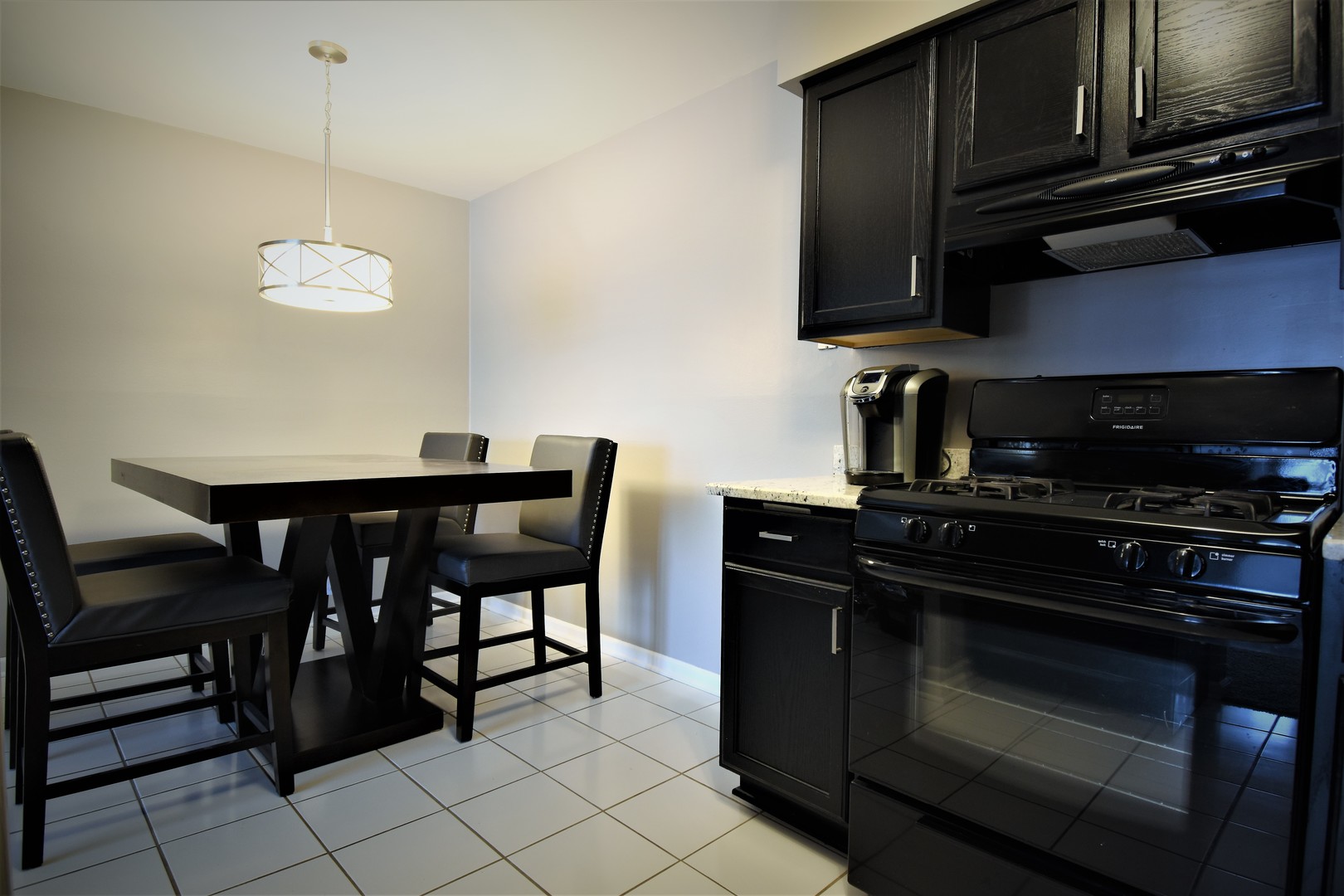 19330 Wolf Road, Unit 5 Mokena, IL 60448 - Photo 10 of 25 a kitchen with a stove and a microwave