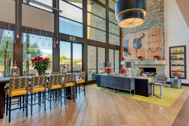 a living room with fireplace furniture and a floor to ceiling window