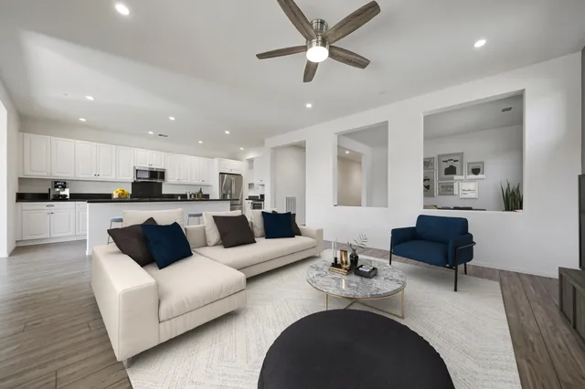 a living room with furniture and kitchen view