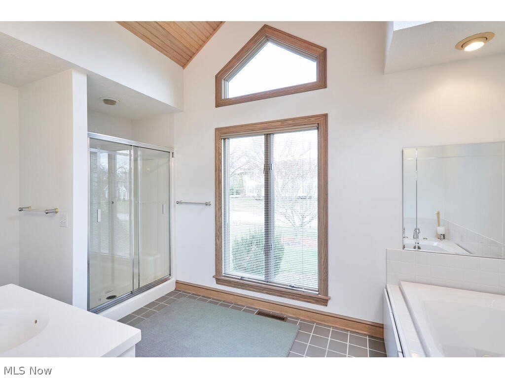 875 Hunter Ridge Circle Fairlawn, OH 44333 - Photo 21 of 34 Master bath with separate shower and whirlpool tub.This bath is accented with planked vaulted ceiling too!
