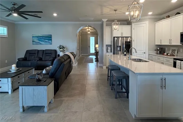 a bedroom with a bed a flat screen tv and a couch