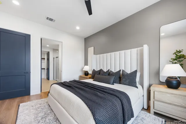 a bedroom with bed and a night stand