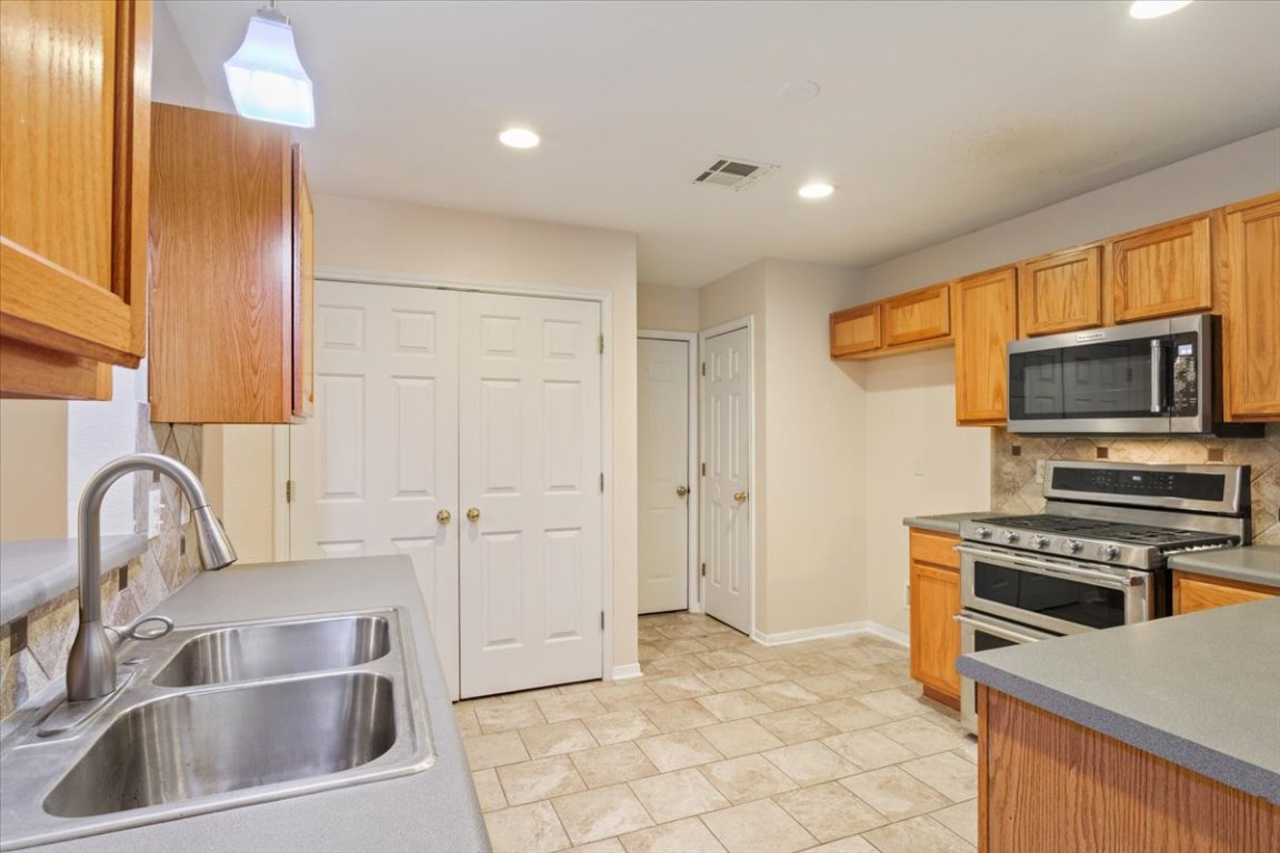 314 Katy Crossing Georgetown, TX 78626 - Photo 16 of 38 a kitchen that has a sink and a stove top oven