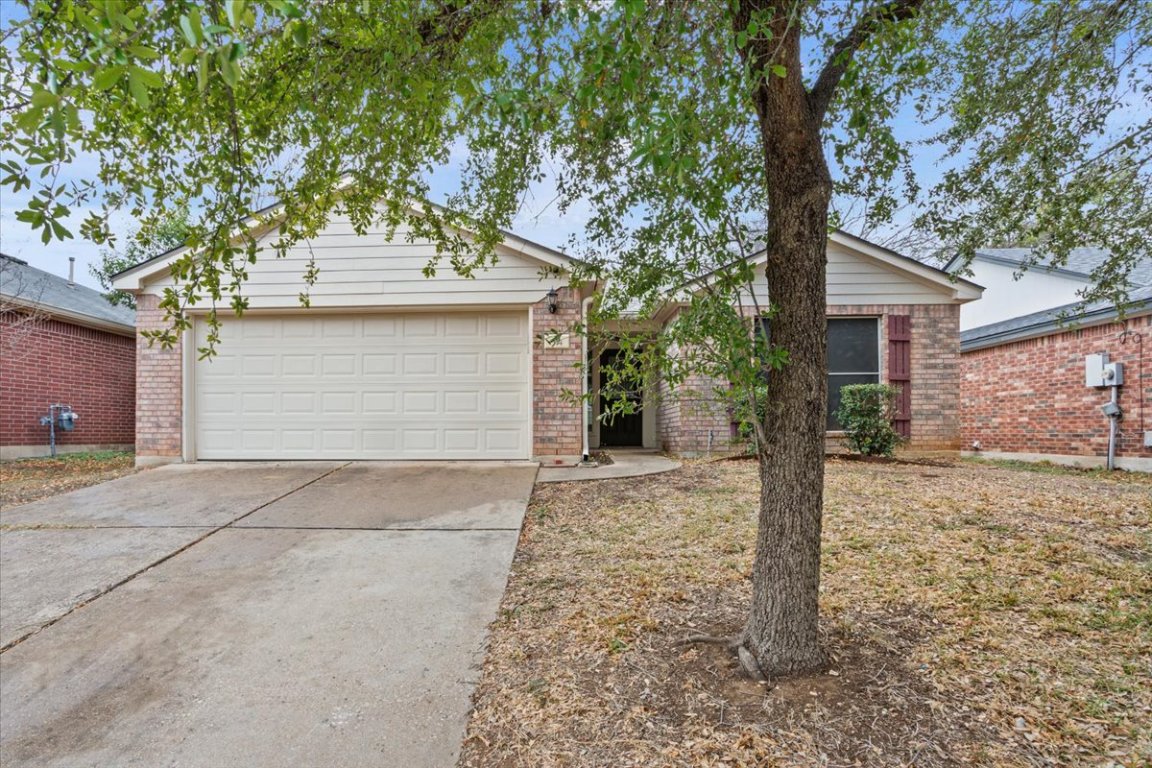 314 Katy Crossing Georgetown, TX 78626 - Photo 2 of 38 a front view of a house with a yard and garage