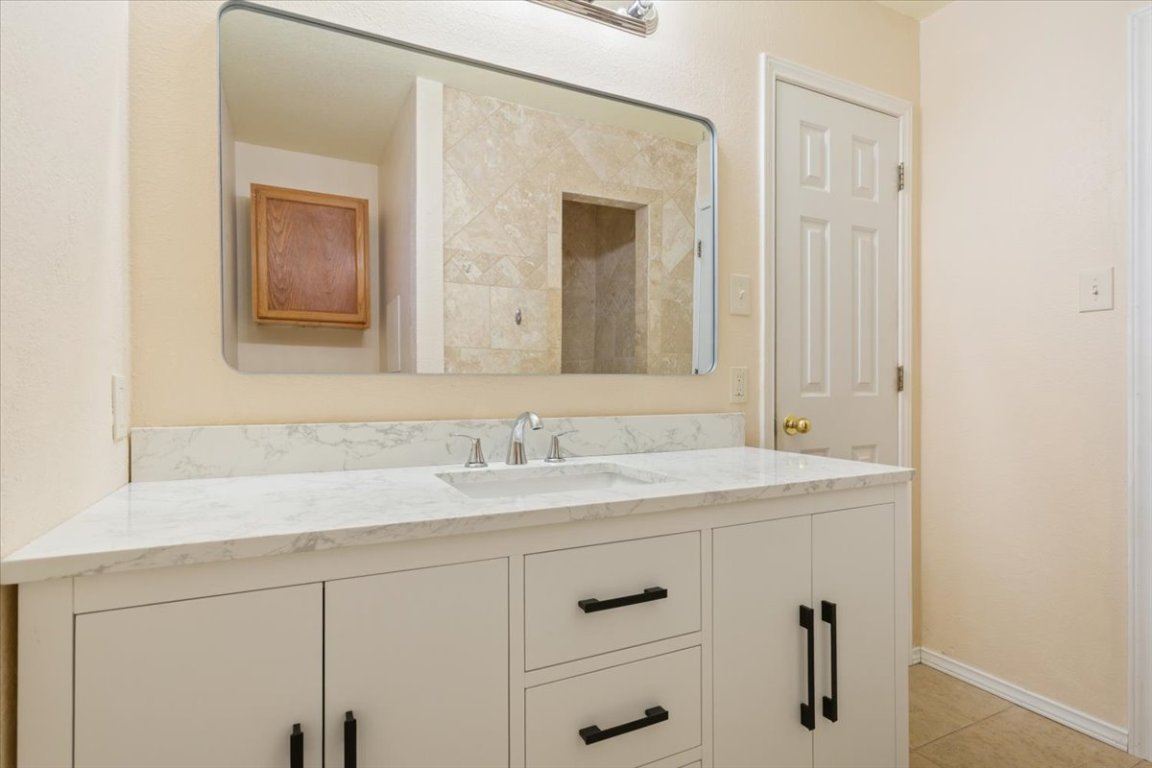 314 Katy Crossing Georgetown, TX 78626 - Photo 23 of 38 a bathroom with a sink and a mirror