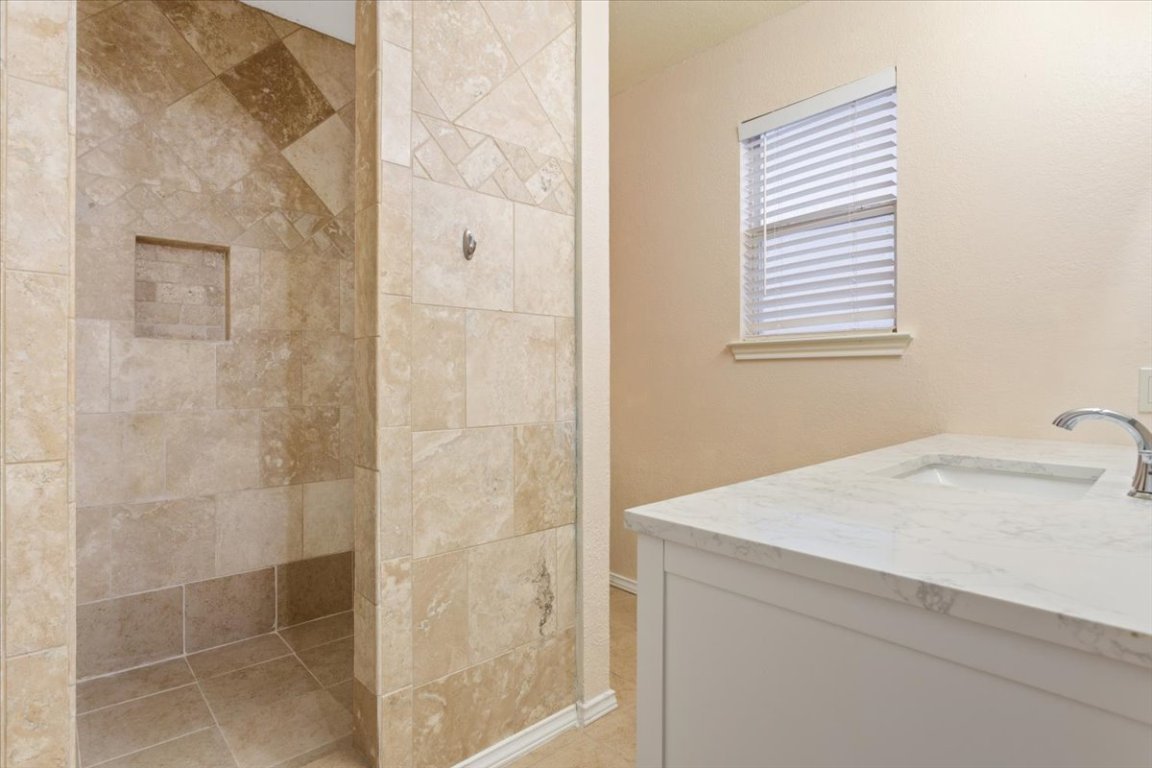 314 Katy Crossing Georgetown, TX 78626 - Photo 24 of 38 a bathroom with a sink and a shower