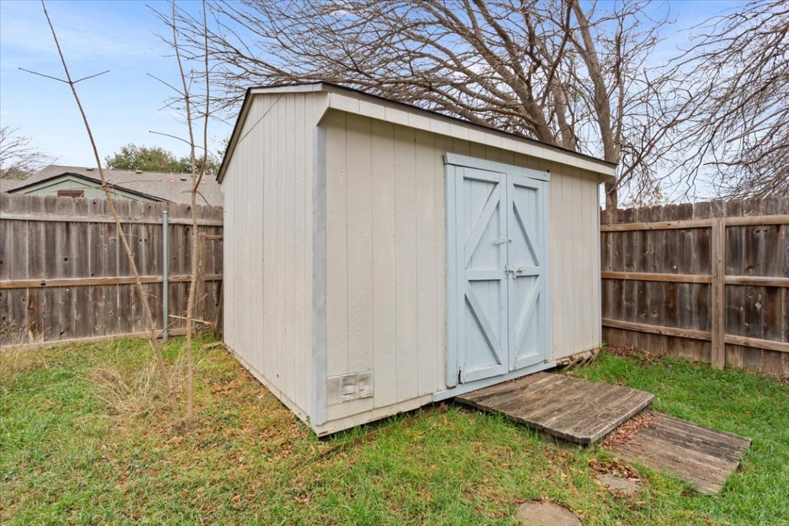 314 Katy Crossing Georgetown, TX 78626 - Photo 37 of 38 a view of a backyard with a small cabin and wooden fence
