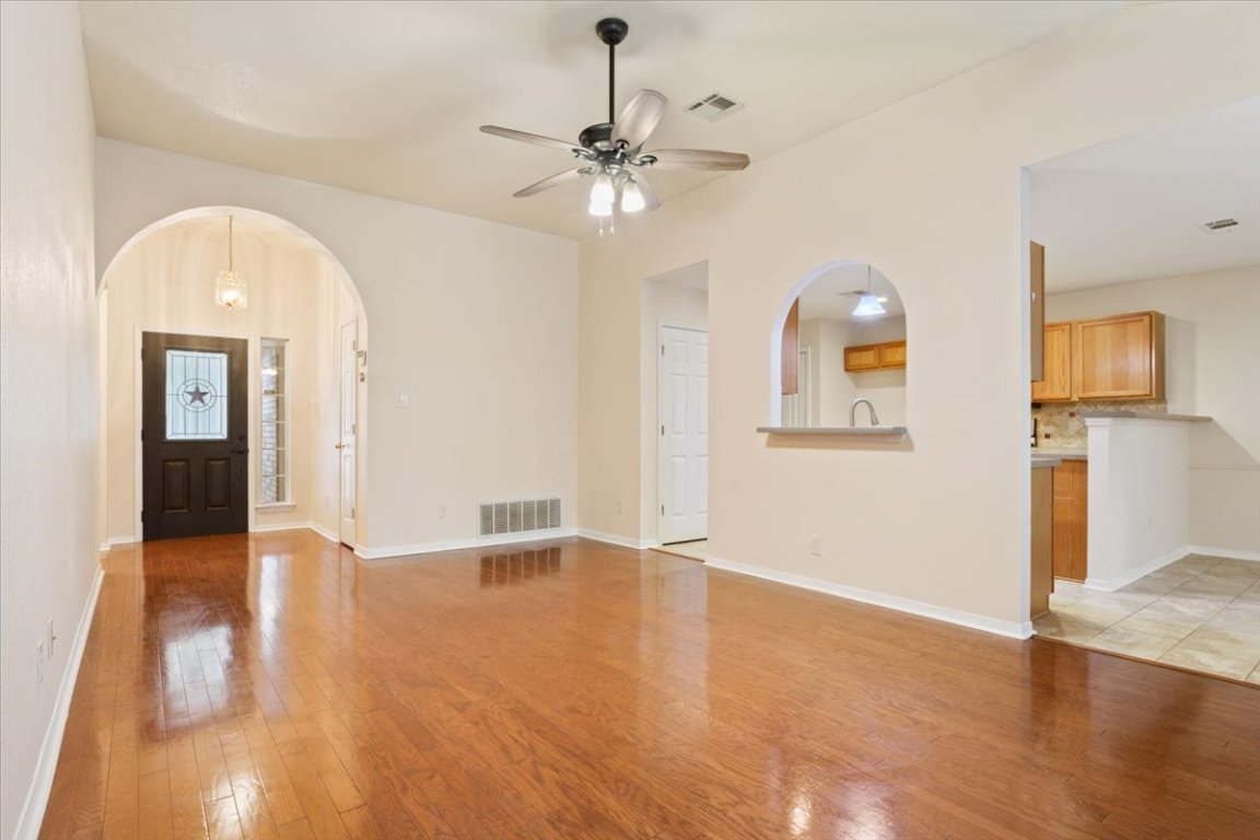 314 Katy Crossing Georgetown, TX 78626 - Photo 6 of 38 a view of a livingroom with wooden floor and a ceiling fan