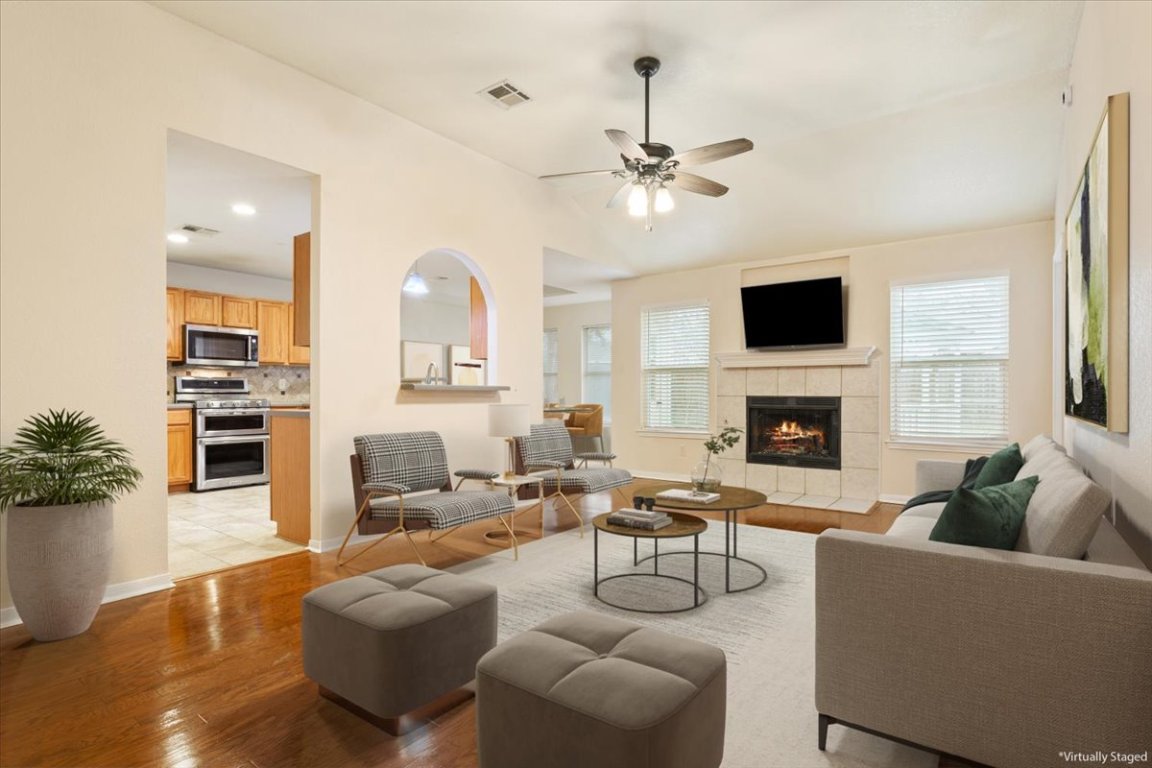 314 Katy Crossing Georgetown, TX 78626 - Photo 9 of 38 a living room with furniture a fireplace and a flat screen tv