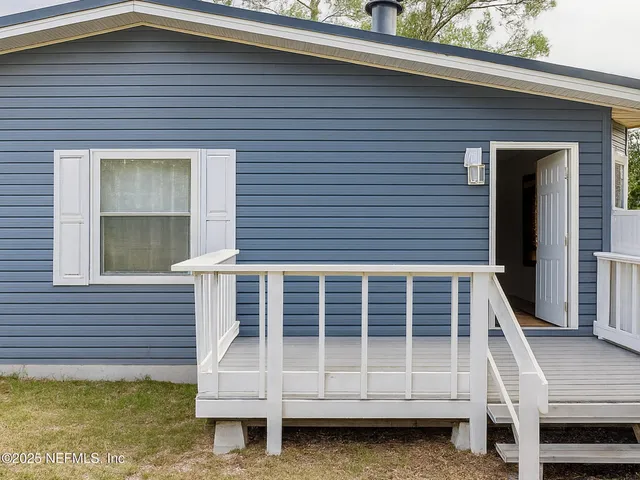 a front view of a house with a large window