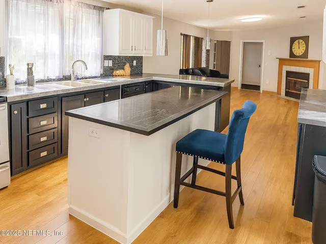 a kitchen with stainless steel appliances granite countertop a sink a stove and a refrigerator