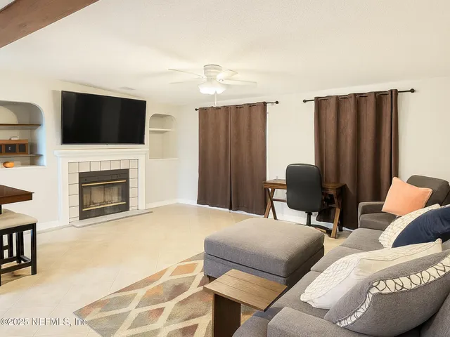 a bedroom with furniture and a flat screen tv