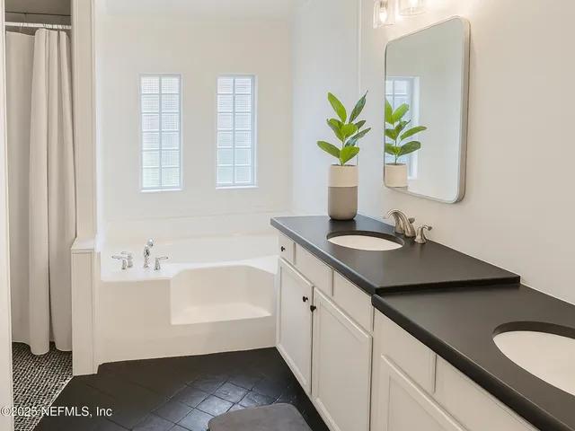 a bathroom with a sink double vanity and a mirror