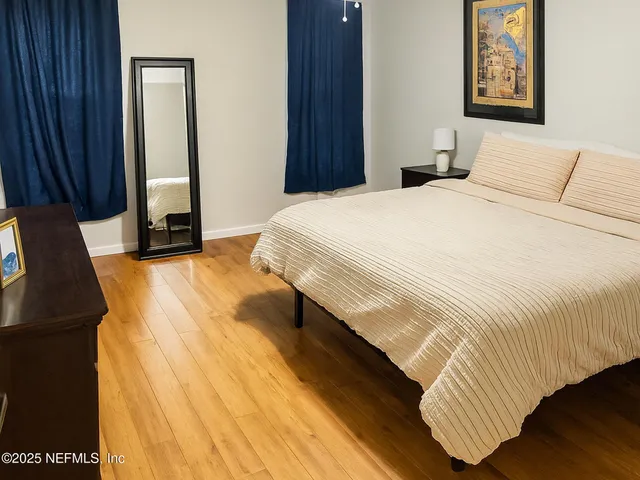 a bedroom with a bed and a mirror