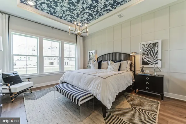 a bedroom with a large bed and a two window