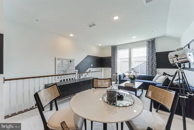 a dining room with furniture a rug and wooden floor