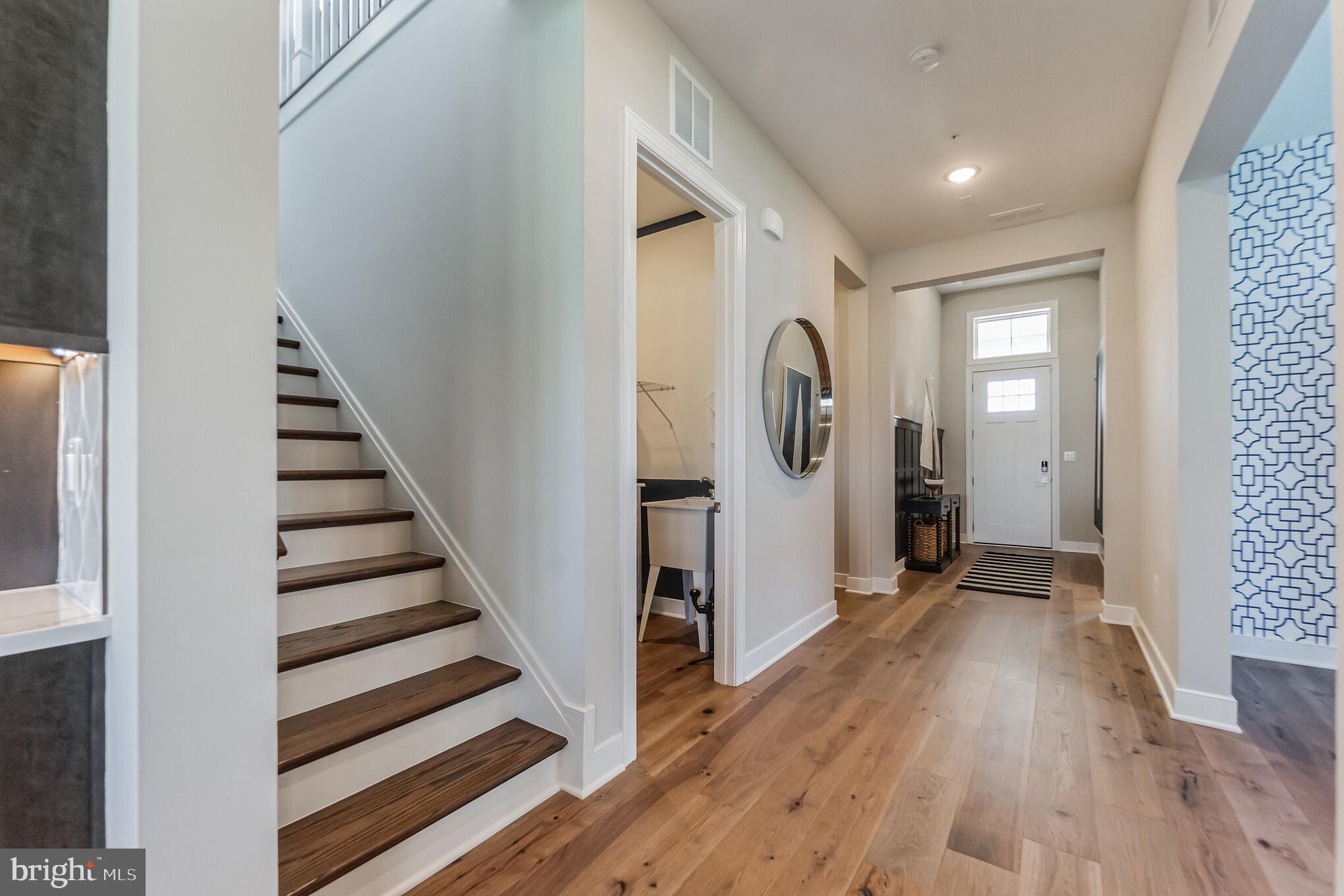 123 Flycatcher Way Chester, MD 21619 - Photo 3 of 47 a view of a hallway with wooden floor and entryway