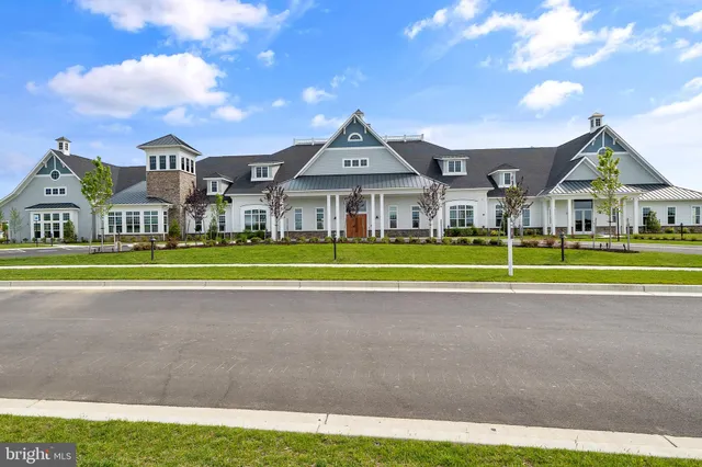 a view of a big house in a big yard with large trees