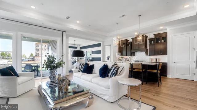 a living room with furniture and view of kitchen