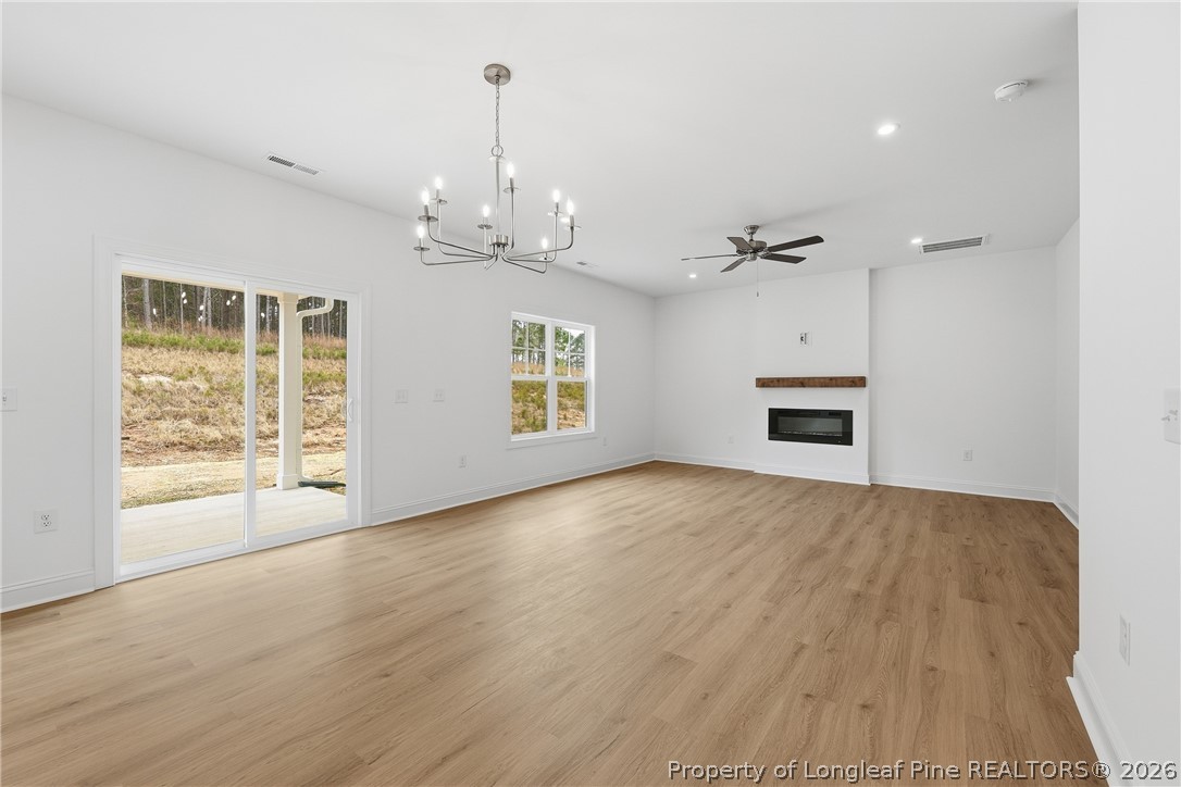 154 Carver Street Carthage, NC 28327 - Photo 14 of 41 a view of empty room with wooden floor and kitchen view