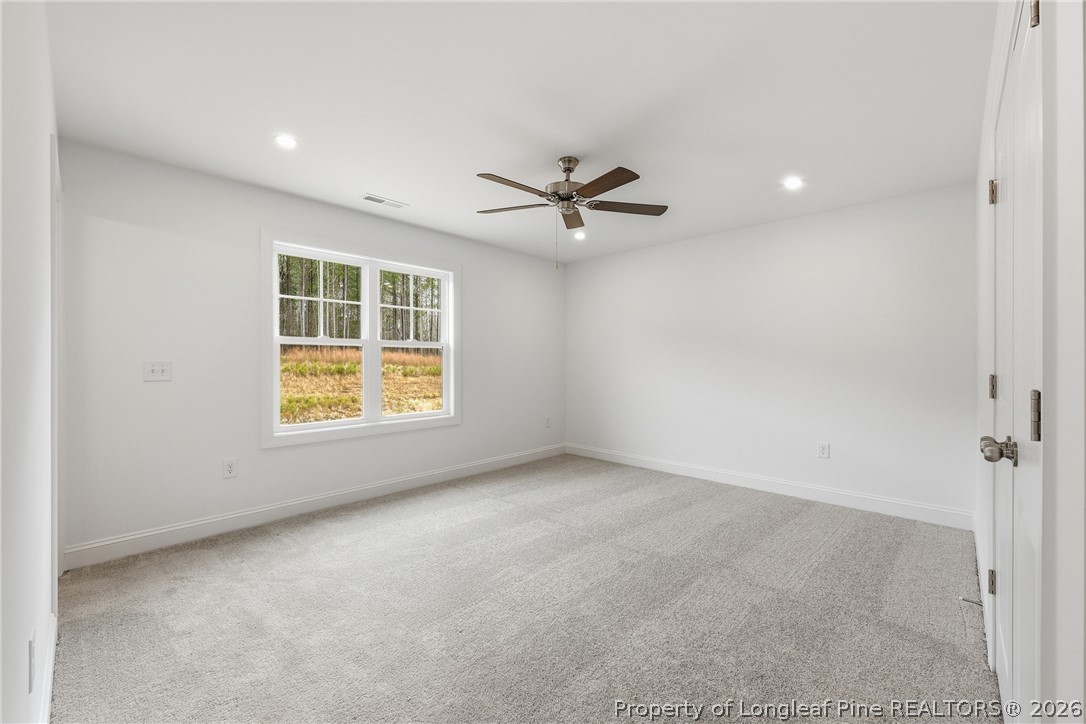 154 Carver Street Carthage, NC 28327 - Photo 19 of 41 an empty room with windows and ceiling fan