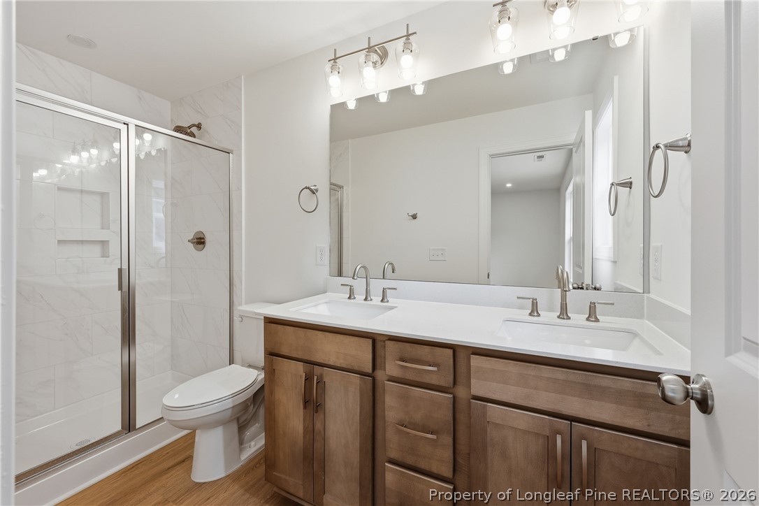 154 Carver Street Carthage, NC 28327 - Photo 22 of 41 a bathroom with a sink toilet a mirror and shower