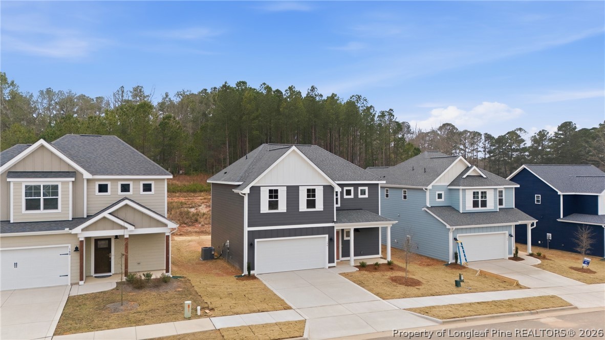 154 Carver Street Carthage, NC 28327 - Photo 4 of 41 a view of a white house next to a yard with large trees